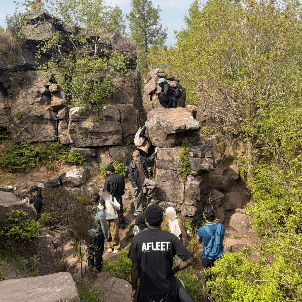Apprentices at a LACE Network outdoor networking event, exploring a rocky outcrop together
